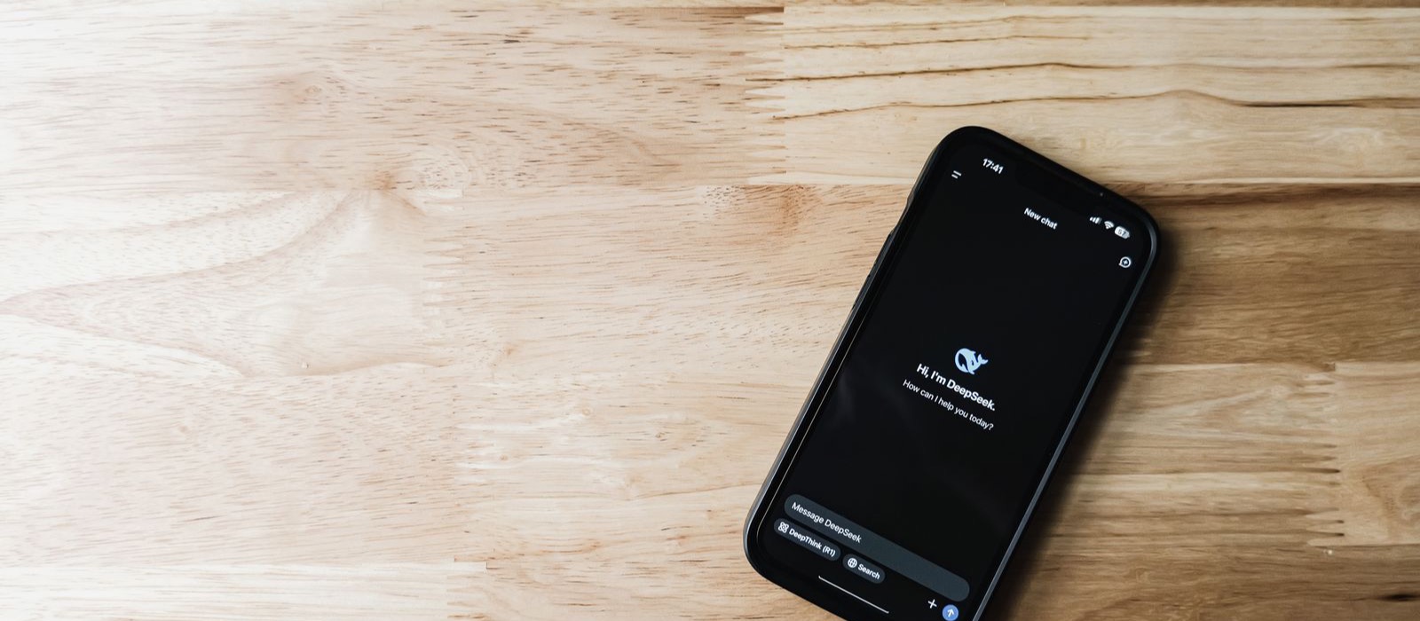 Smartphone showing an AI chatbot interface, representing how customers now ask AI assistants to find local businesses