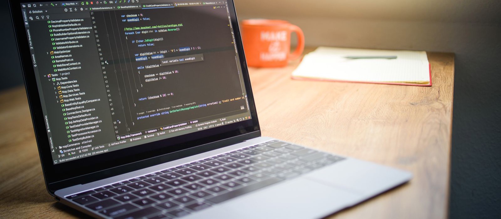 Web designer's workspace with a laptop showing code, representing the cost of building a website in Sydney